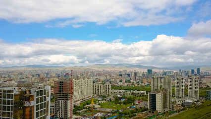 Fototapeta na wymiar Mongolia, Ulaanbaatar Panorama of the city from a bird s-eye view in cloudy weather. Landing, From Drone