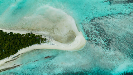 Aerial view of tropical island Mataking with coral reef and atoll view from above. Tun Sakaran...