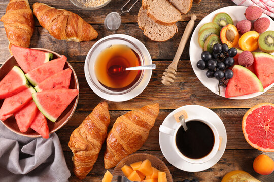 healthy eating- breakfast with coffee and tea, fresh fruits and croissant