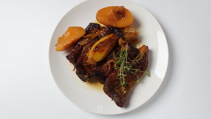 A steak braised herbs, served with boiled  potatoes garnished with fresh oregano.