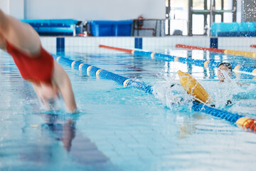 Swimming pool, sports and woman diving in water for training, exercise and workout for competition. Fitness, swimmer and professional person dive, athlete in action and jump for health and wellness.