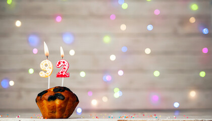 Happy birthday background with muffin and number of candles on light bulbs bokeh background. Greeting card happy birthday copy space with number  92