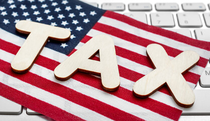 Word TAX with american flag on computer keyboard. Online tax report and payment.