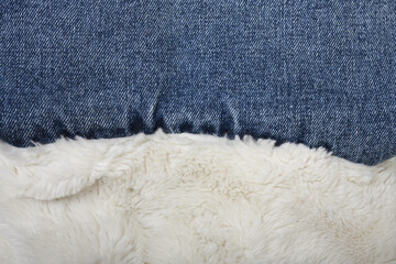 Fototapeta na wymiar Background of white faux fur and jeans.