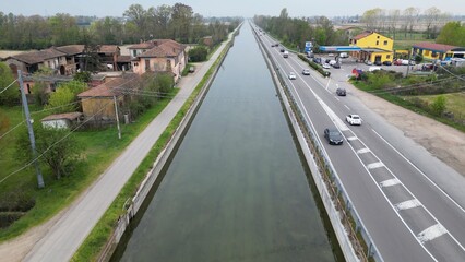 walking and hiking in nature passing through a tree-lined avenue - trees with growing leaves in a park with reflections of the sun and the arrival of spring - Milan Montagnetta di San Siro 