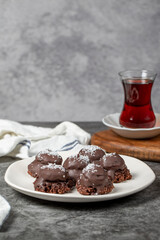 Coconut and chocolate chip cookies..Bakery products. Cookies with tea on dark background