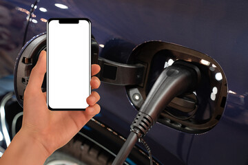 Hand with smartphone on a background of electric car . White screen, you can add your content here..