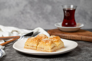 Baklava with milk and hazelnuts. Turkish cuisine delicacies. Baklava with milk on a dark background. Local name sutlu nuriye.