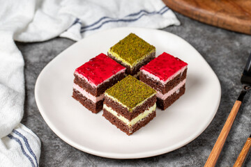 Small cake slices. Pistachio and raspberry cake slices. Set of different tartlets or cakes. Bakery products