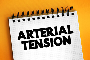 Arterial tension - the pressure of the blood within an artery, text concept on notepad