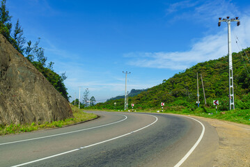 Serpentine asphalt road in the mountains and blue sky