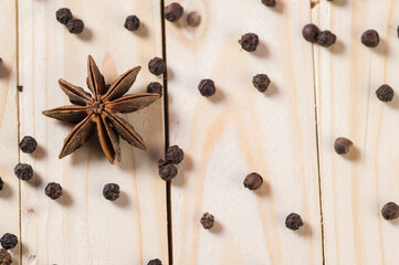 Spices and herbs. Food and cuisine ingredients. anise stars and black peppercorns on a wooden background. - obrazy, fototapety, plakaty