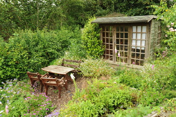 Picnic table and garden shed in an very English garden