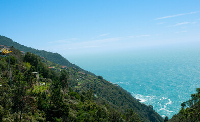 Front view, from a mountain road, of shoreline of the Mediterranean sea, on a sunny day