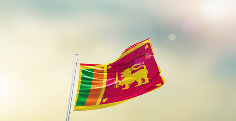Waving Flag of Sri Lanka on blur sky. The symbol of the state on wavy cotton fabric.