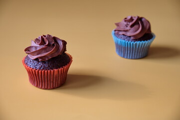 Closeup of chocolate muffins against yellow background