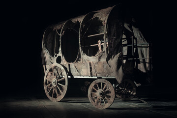 Vintage wooden wagon or carriage on the dark background