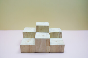 Wood podium stand for display on yellow and pink background