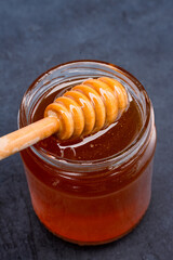 Jar of honey and honey spoon
