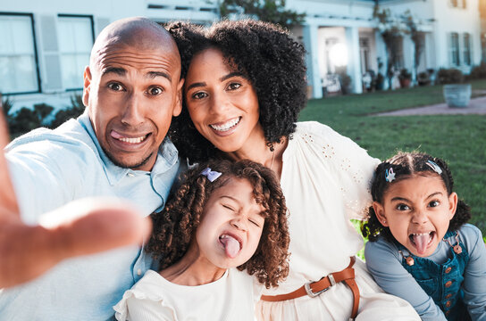 Family, silly selfie and outdoor with children and parents in backyard for love and care. Happy kids, man and woman together for support with hug, smile and tongue out for comic or funny portrait