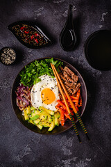 Traditional Korean dish Bibimbap: rice with vegetables beef and egg.