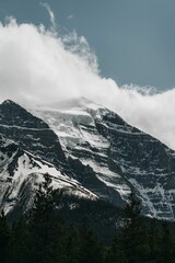 Beautiful view of a snowy mountain with a cloudy sky background