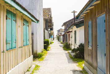 Cap Ferret alley between traditional fishermen's houses during a sunny day