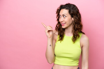 Young caucasian woman isolated on pink background intending to realizes the solution while lifting a finger up