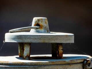 Selective focus closeup of an old rusted metal cover of a well