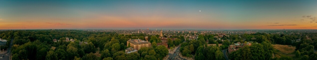 Fototapeta na wymiar Panoramic shot of the Hampstead with multiple buildings and roads at sunset