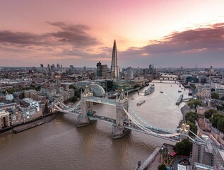 Aerial view of Tower Bridge and The Shard at pinky dreamy sunset in London
