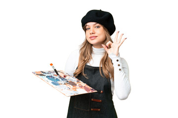 Young artist girl holding a palette over isolated chroma key background showing ok sign with fingers