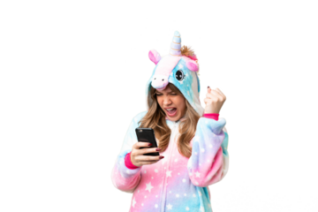Young girl with unicorn pajamas over isolated chroma key background with phone in victory position