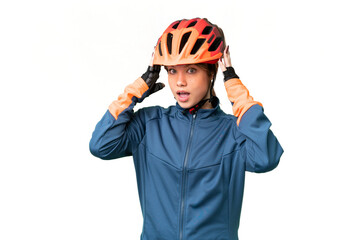 Young cyclist girl over isolated chroma key background with surprise expression