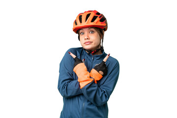 Young cyclist girl over isolated chroma key background pointing to the laterals having doubts