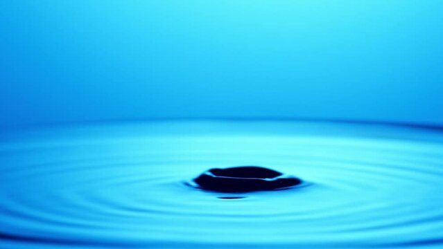 water drop splash. ripples in water. water splash in blue. blue water background