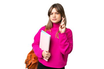 Young student girl over isolated chroma key background with fingers crossing and wishing the best