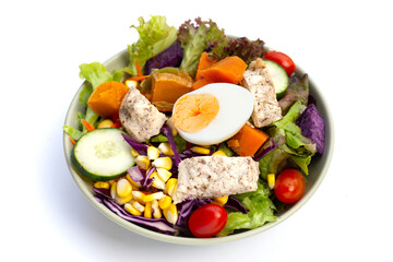 Salad with meat and vegetables in bowl on white background.