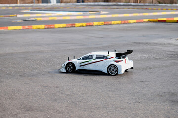 RC radio control model car at race track, modelling vehicle on the asphalt at a real extreme...