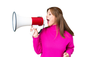Middle age woman over isolated background shouting through a megaphone to announce something in lateral position