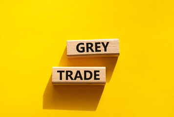 Grey trade symbol. Wooden blocks with words grey trade. Beautiful yellow background. Business and grey trade concept. Copy space.