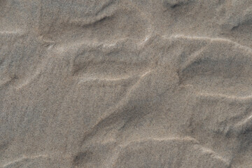 Photo texture of wet sand on the beach.