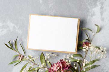 Wedding invitation or greeting card mockup with eucalyptus, gypsophila and hydrangea flowers