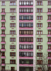 a green-rose house with windows
