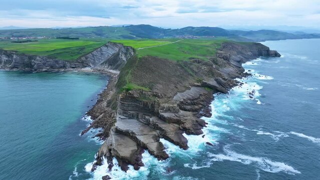 Coastal landscape of cliffs, meadows and sea in the area of Punta Ballota between Tagle and Ubiarco. Aerial view from a drone. Cantabrian Sea. Cantabria, Spain, Europe