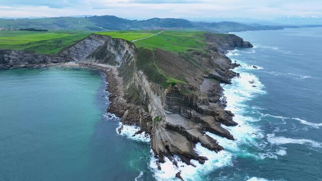 Coastal landscape of cliffs, meadows and sea in the area of Punta Ballota between Tagle and Ubiarco. Aerial view from a drone. Cantabrian Sea. Cantabria, Spain, Europe