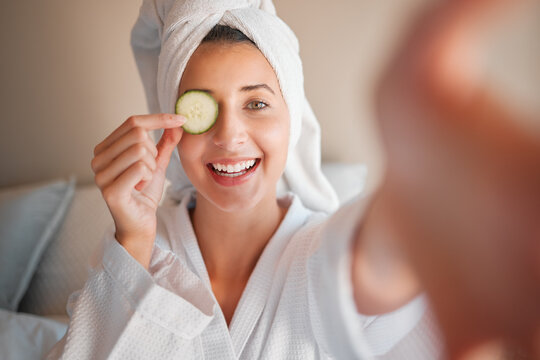 Woman, spa and selfie with cucumber on eye in comic portrait for wellness, self care and relax. Girl, fruit and face for skincare, health and smile for cosmetics, beauty and natural glow in morning - Powered by Adobe
