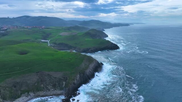 Coastal landscape of cliffs, meadows and sea in the area of Punta Ballota between Tagle and Ubiarco. Aerial view from a drone. Cantabrian Sea. Cantabria, Spain, Europe