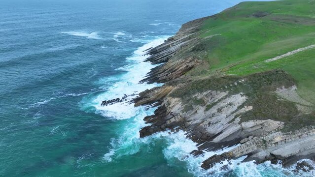 Coastal landscape of cliffs, meadows and sea in the area of Punta Ballota between Tagle and Ubiarco. Aerial view from a drone. Cantabrian Sea. Cantabria, Spain, Europe