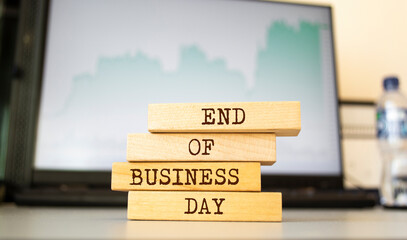 Wooden blocks with words 'end of business day'. Business concept